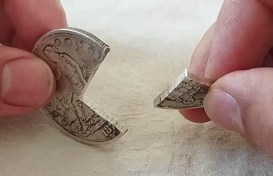 Fake Trade Dollar cut open to show its cross-section