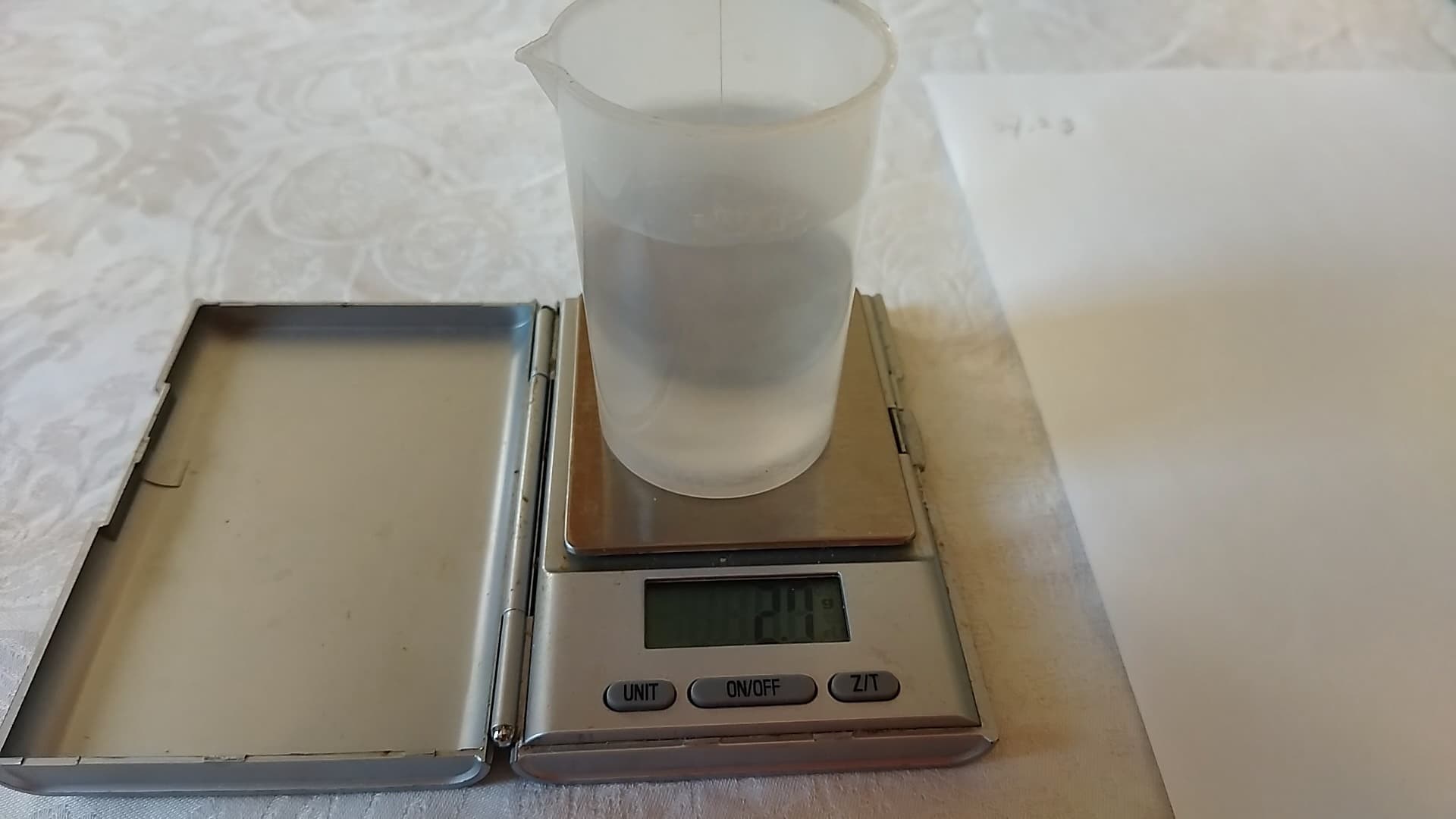Scale reading 2.7 g of displaced water, giving a volume of about 2.7 cm³